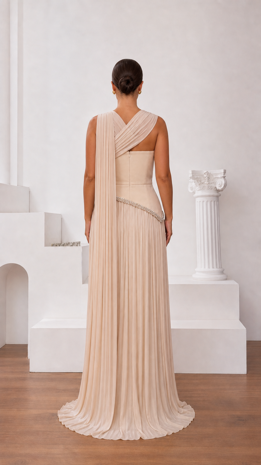 Back view of champagne pleated maxi gown with asymmetrical strap
