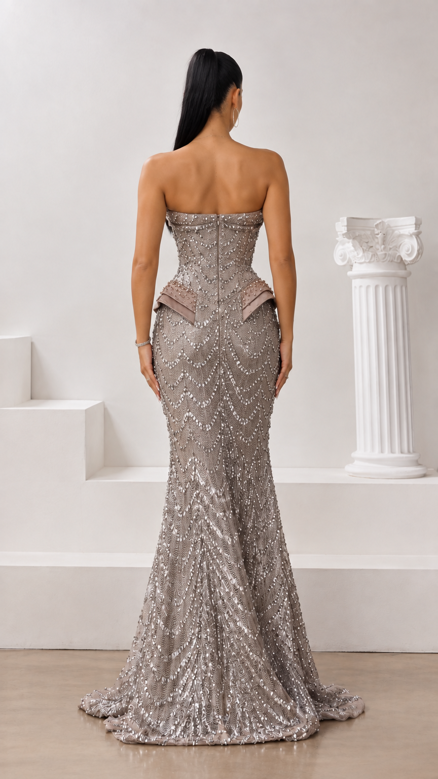 Back view of taupe strapless beaded gown with hidden zipper closure and floor-length skirt