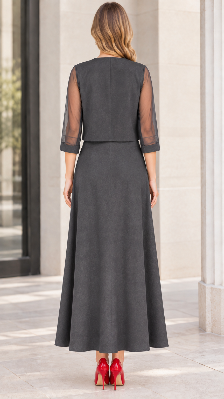 Back view of charcoal grey formal dress set showing cropped jacket and sheer sleeves