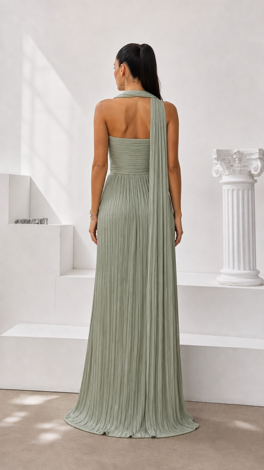 Back view of sage green strapless maxi dress with flowing attached cape scarf