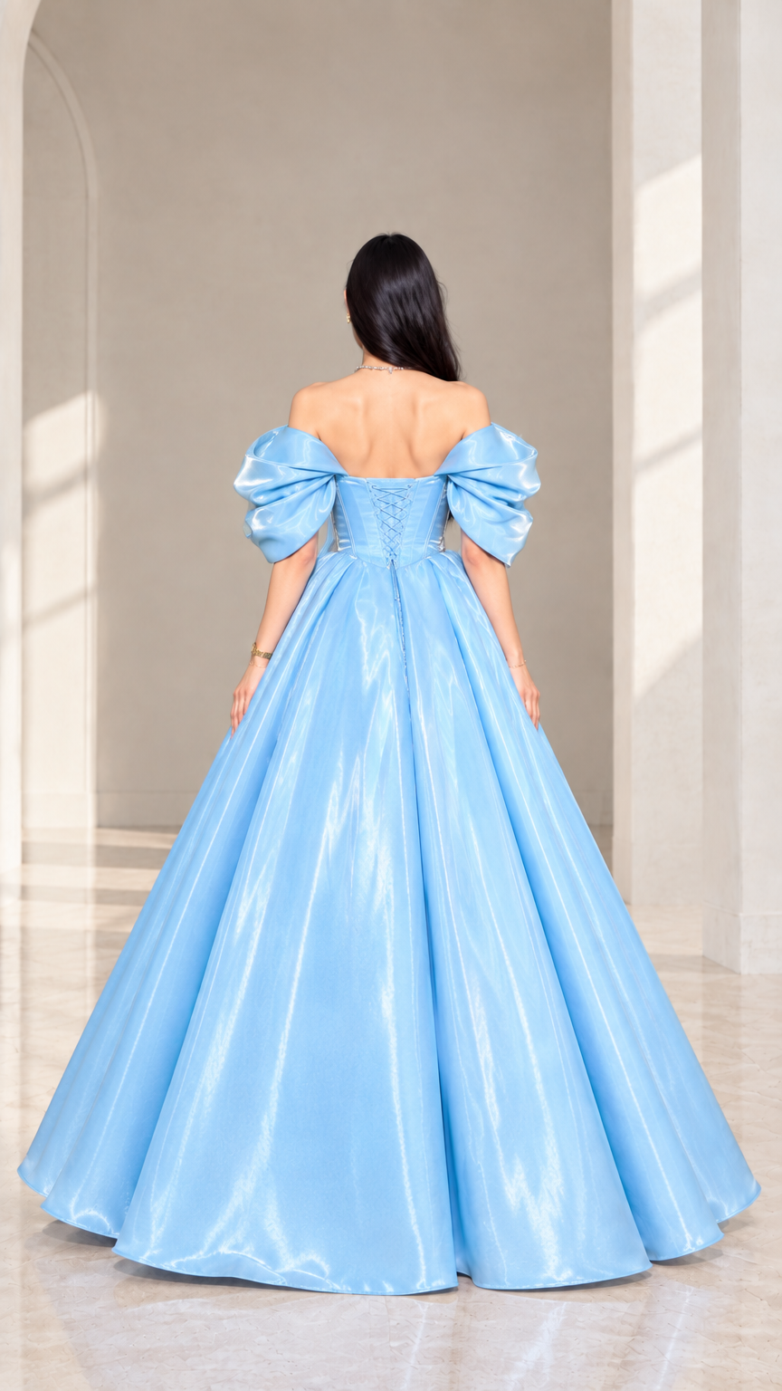Rear view of model wearing sky blue formal ball gown highlighting lace-up back