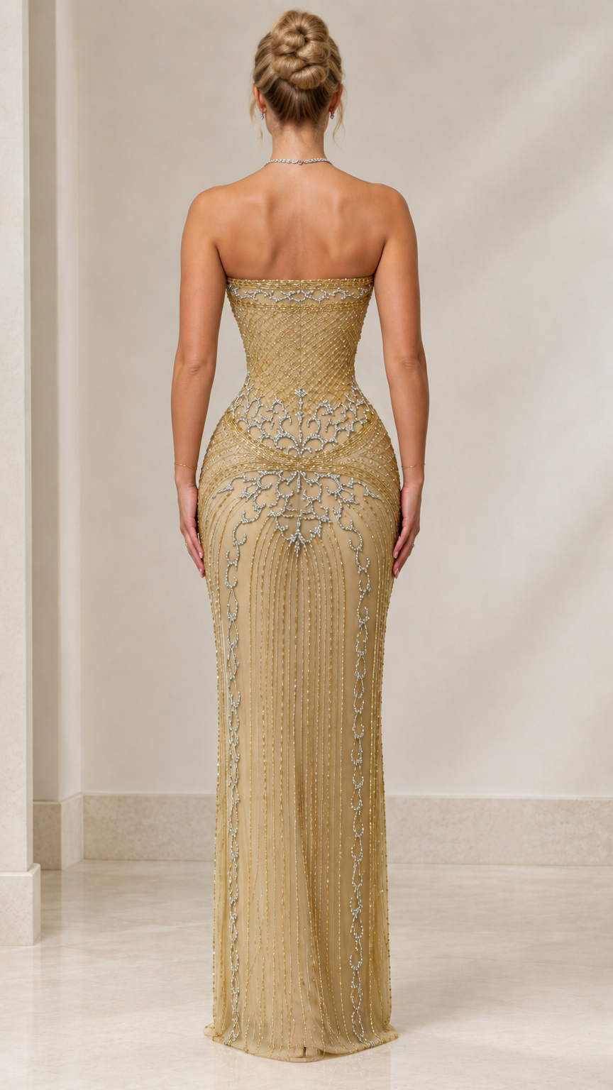 Back view of gold strapless beaded evening gown showing sleek fit