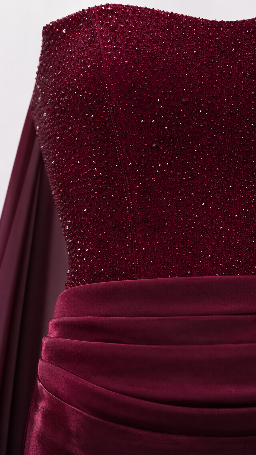 Close-up detail of sparkling crystal beaded bustier bodice and ruched waist on burgundy gown