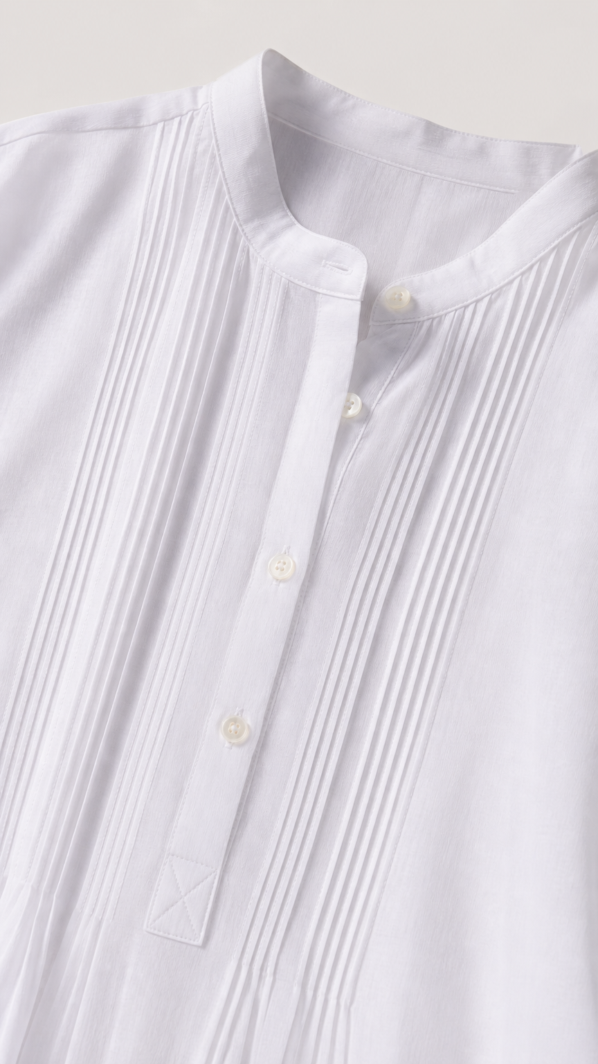 Close-up detail of white shirt dress stand collar and vertical pintuck pleating