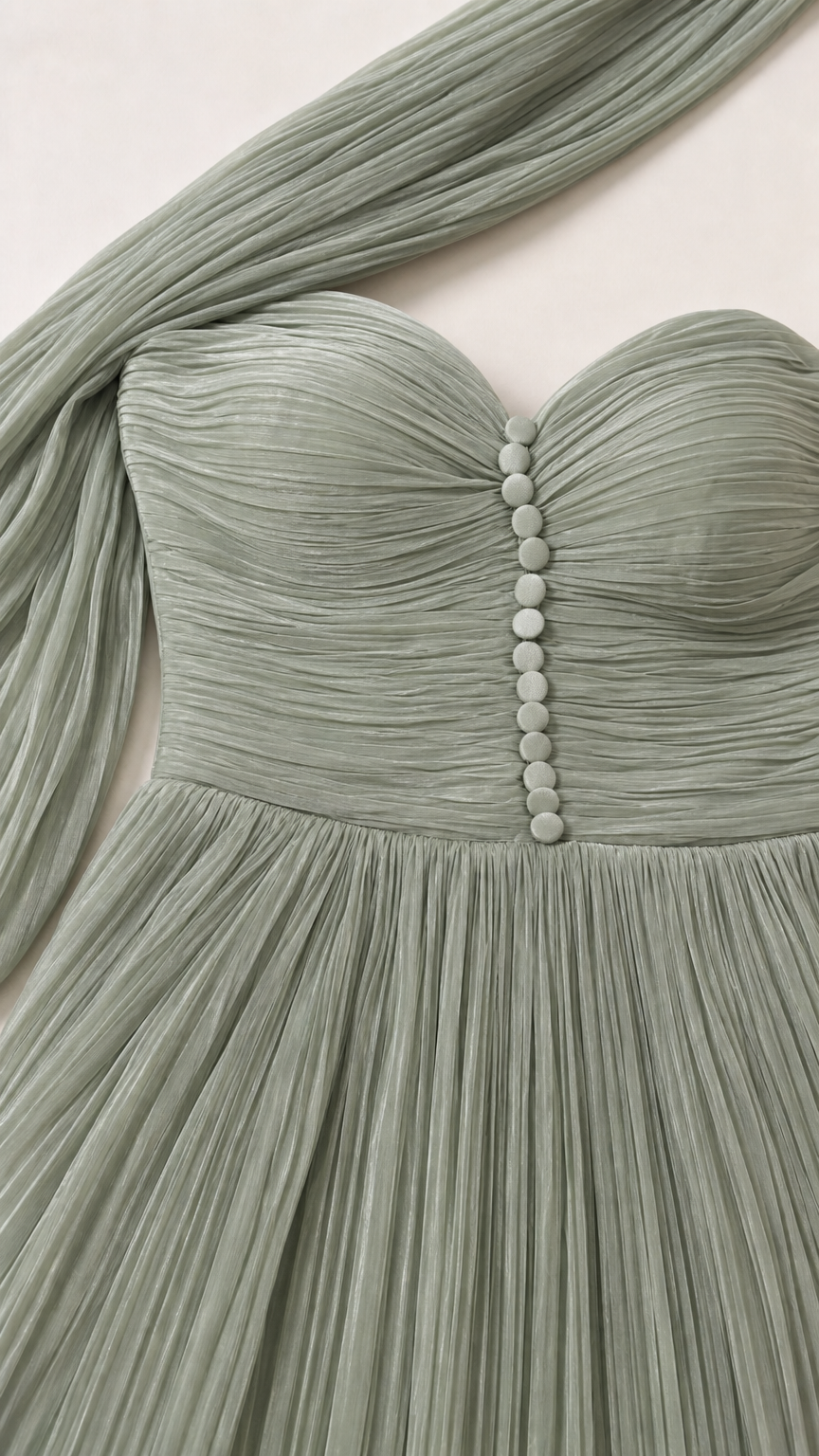Close-up detail of pleated sweetheart neckline with covered buttons in sage green