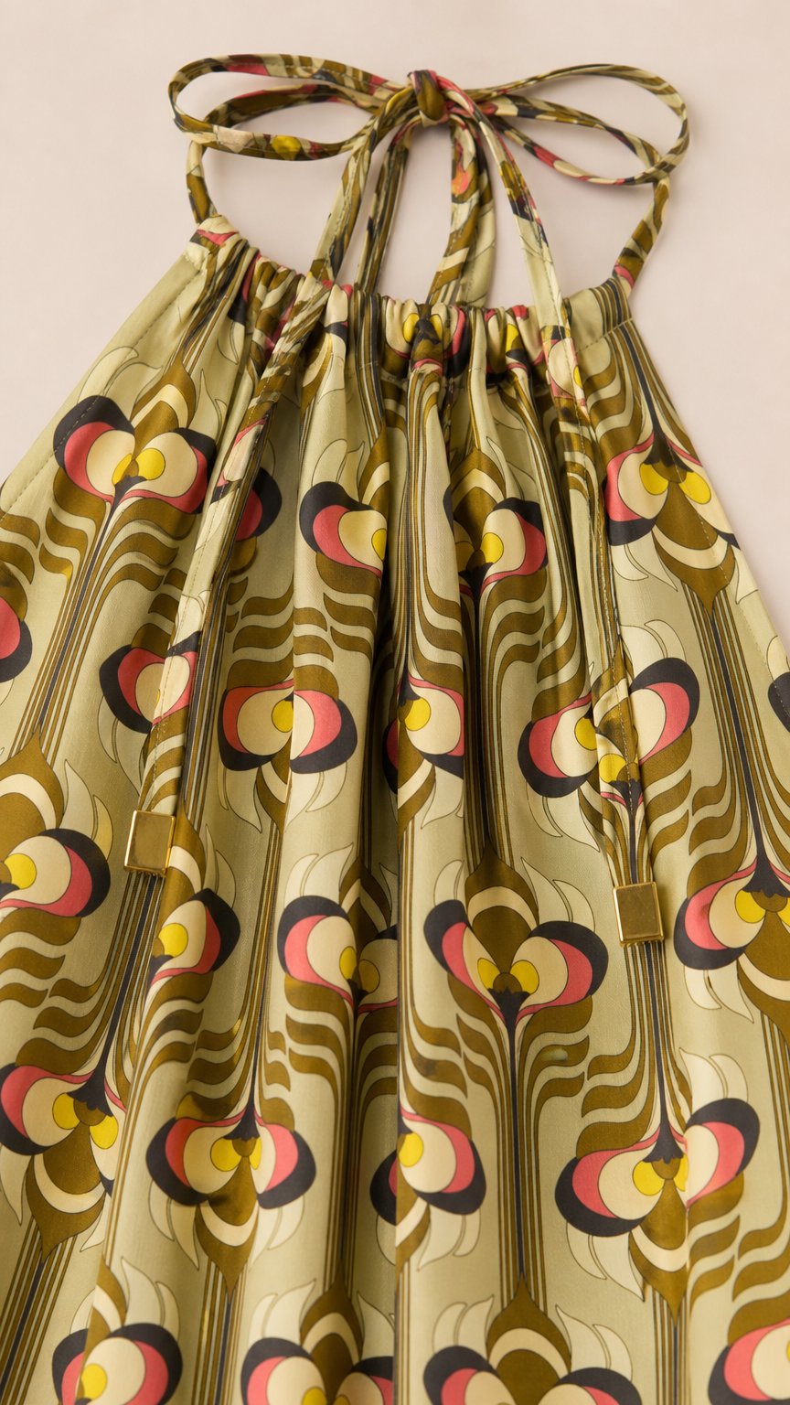 Close-up detail of the gathered halter neckline with adjustable ties and retro geometric fabric pattern