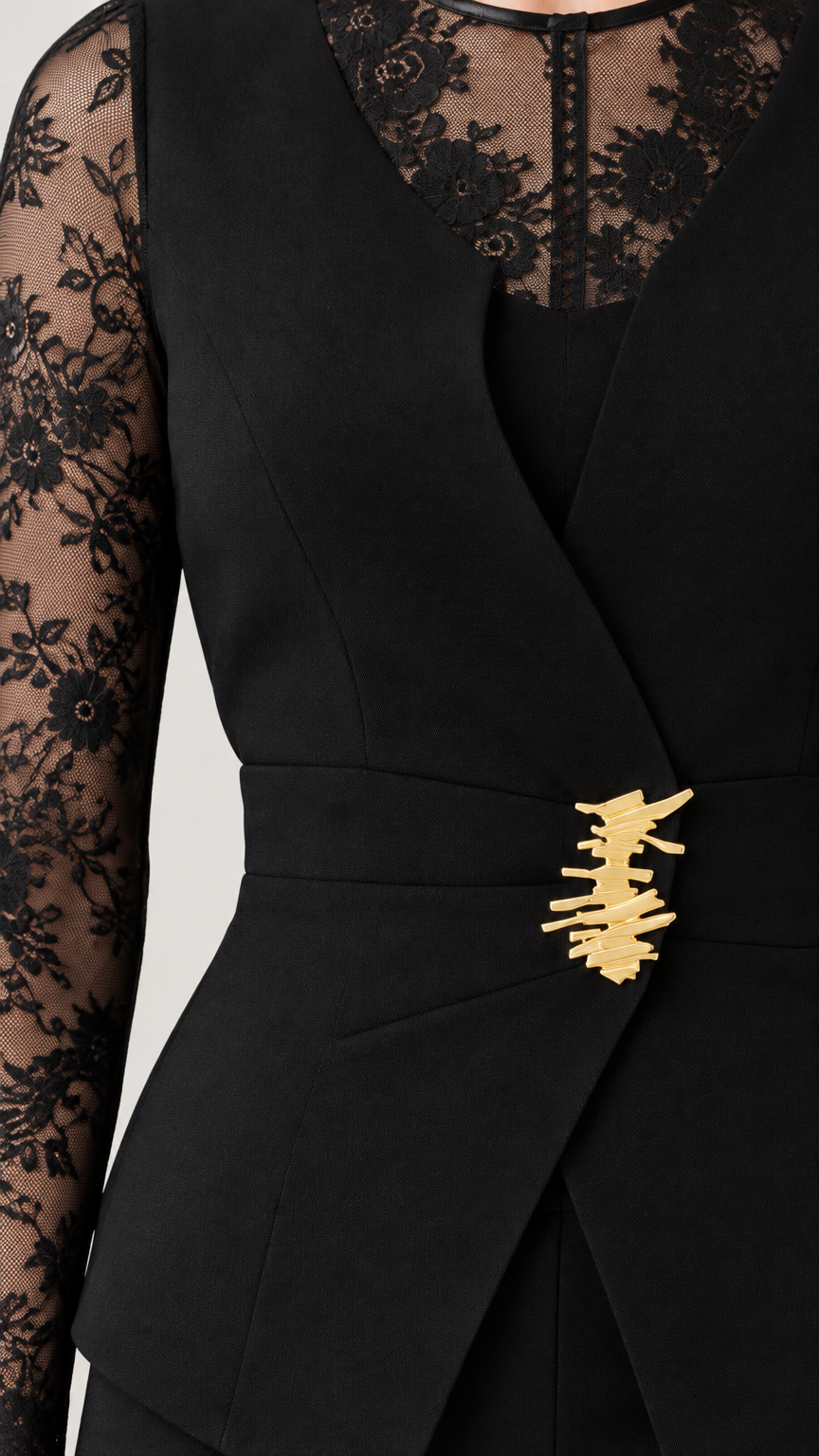 Close-up of black blazer top showing sheer floral lace neckline and gold-tone waist clasp