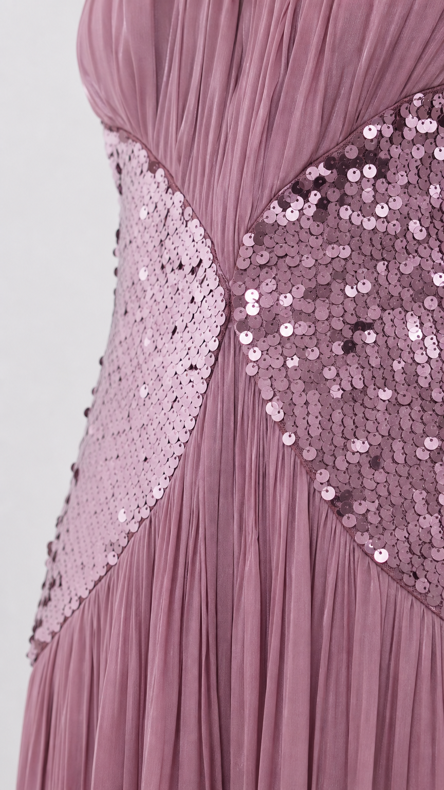Close up view of mauve pleated fabric and circular sequin waist detail