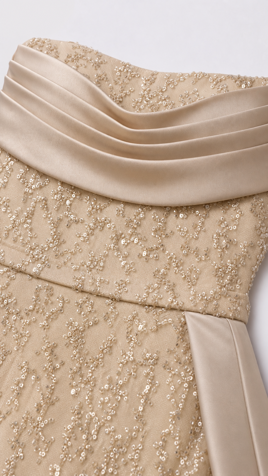 Close up of champagne draped satin neckline and intricate sequin detailing