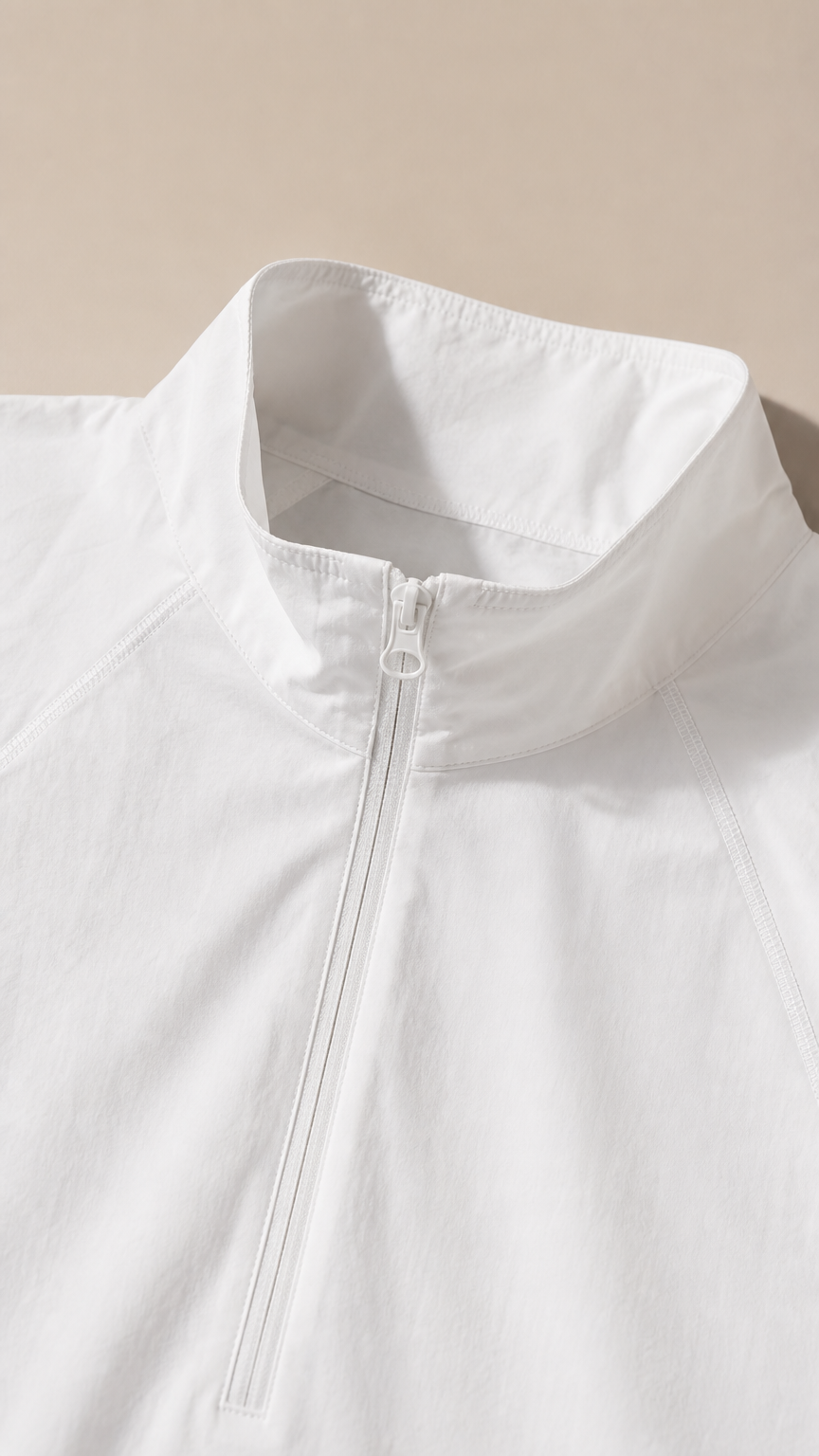 Close-up detail of white windbreaker stand collar and matching front zipper