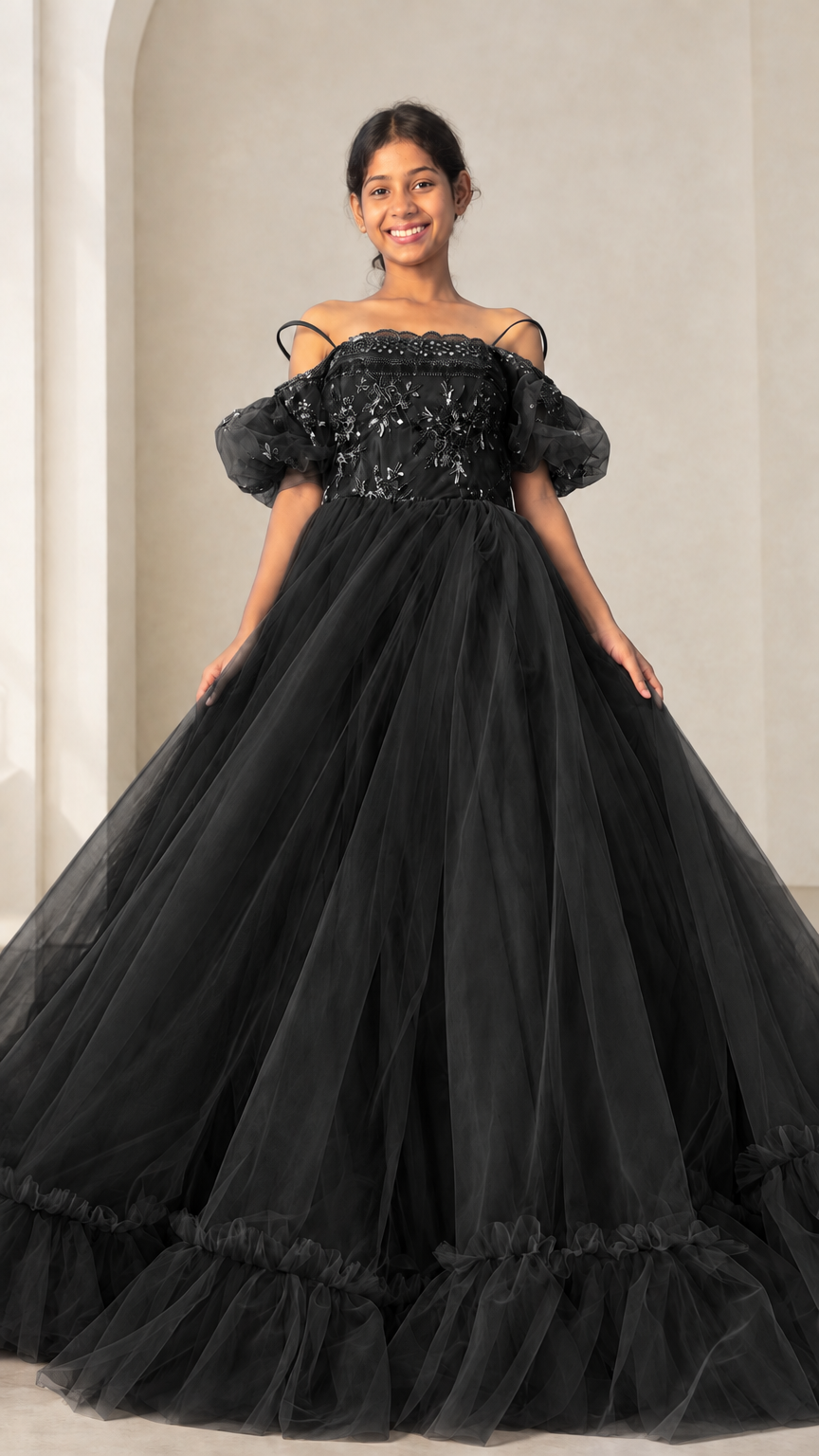Full front view of black embroidered off-shoulder tulle ballgown