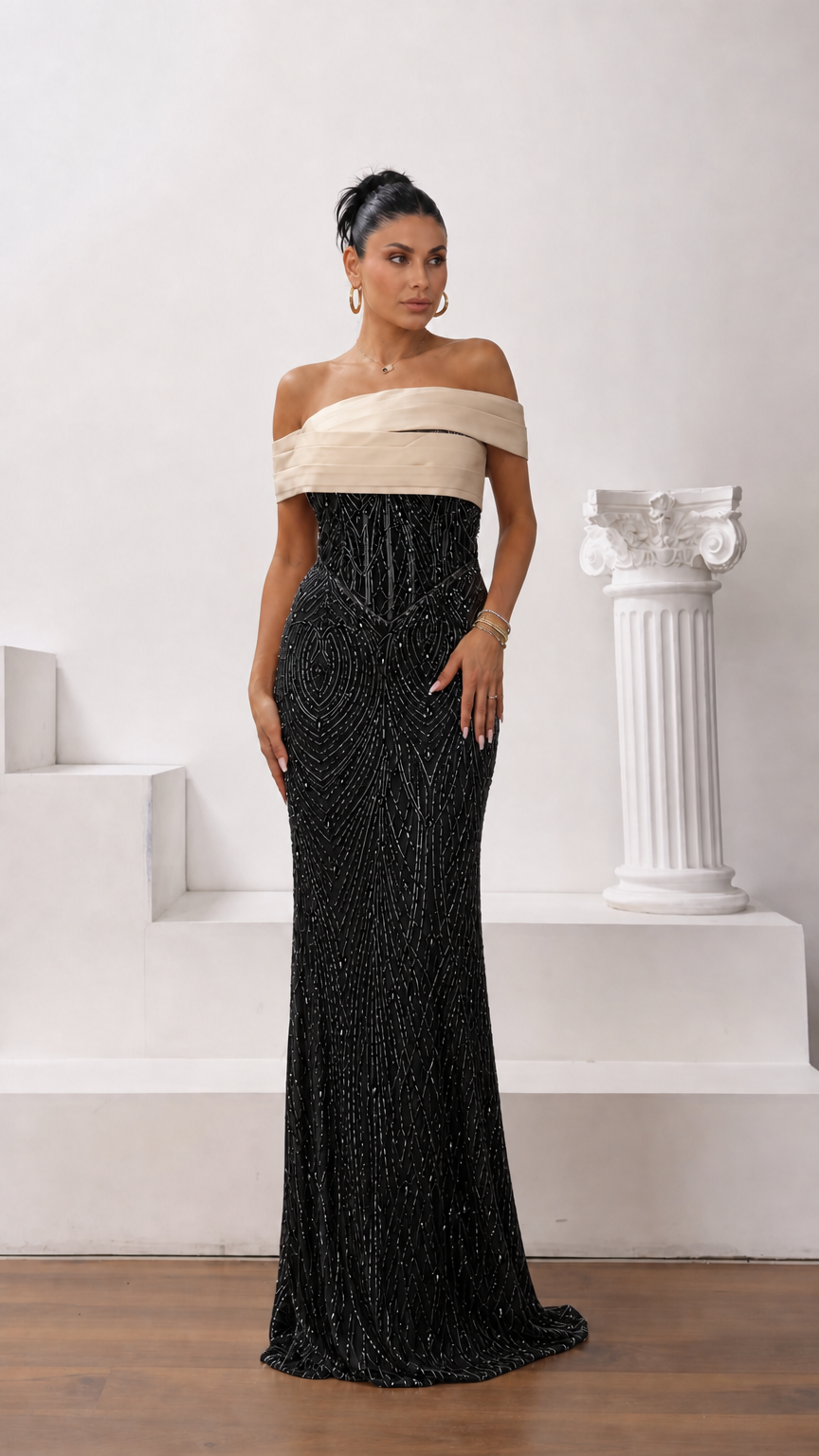 Model wearing black and champagne two-tone off-the-shoulder beaded evening gown