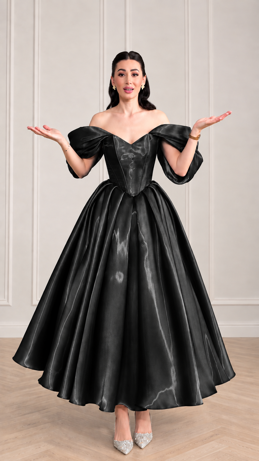 Woman wearing black off-the-shoulder corset satin evening gown with voluminous flared skirt