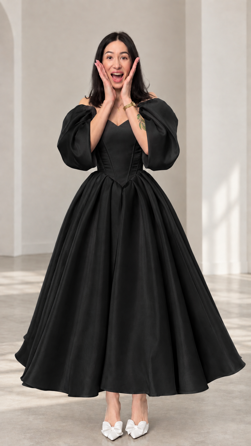 Front view of a woman wearing a black off-shoulder puff sleeve ball gown