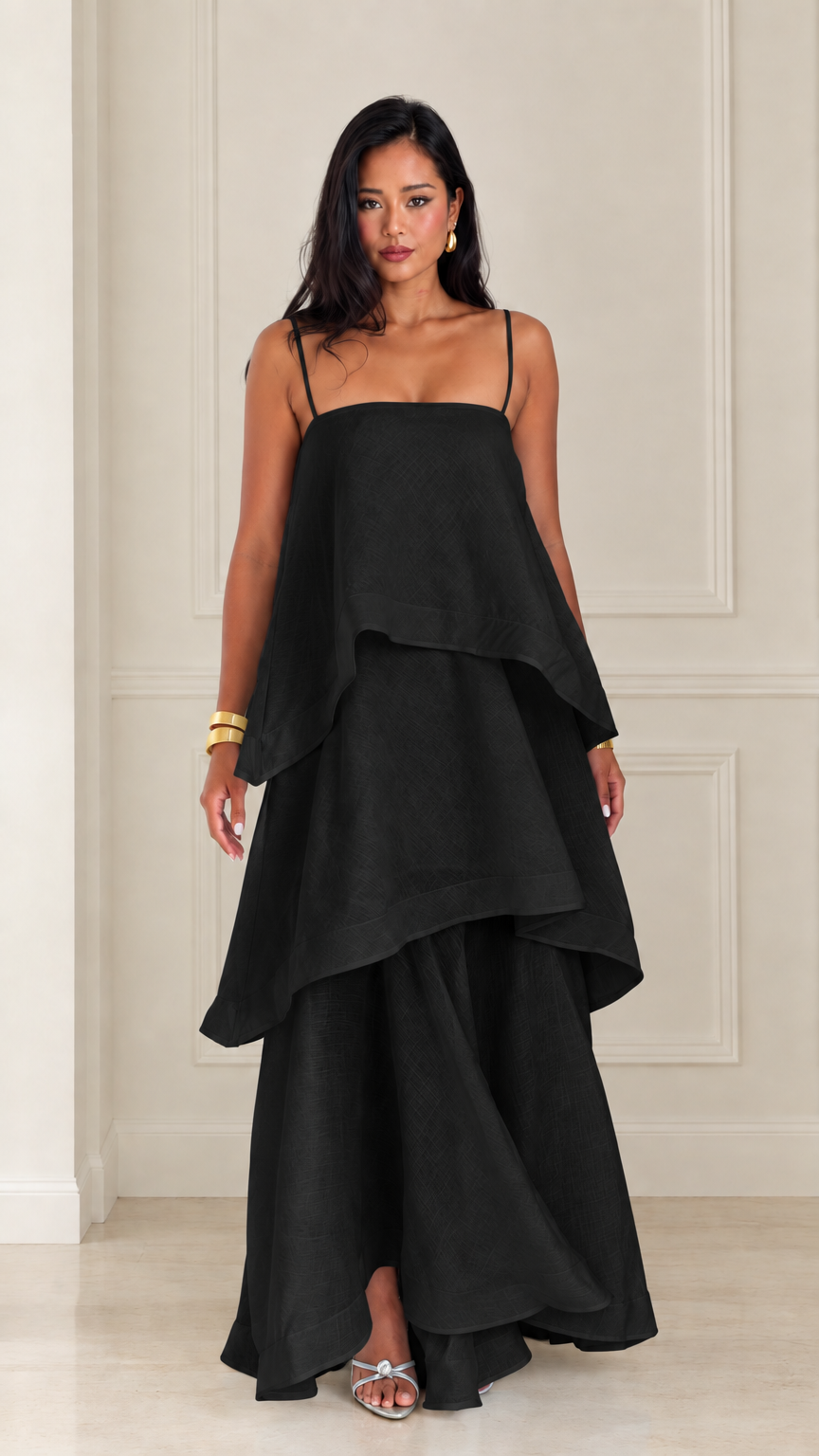 Front view of woman wearing black tiered spaghetti strap maxi dress
