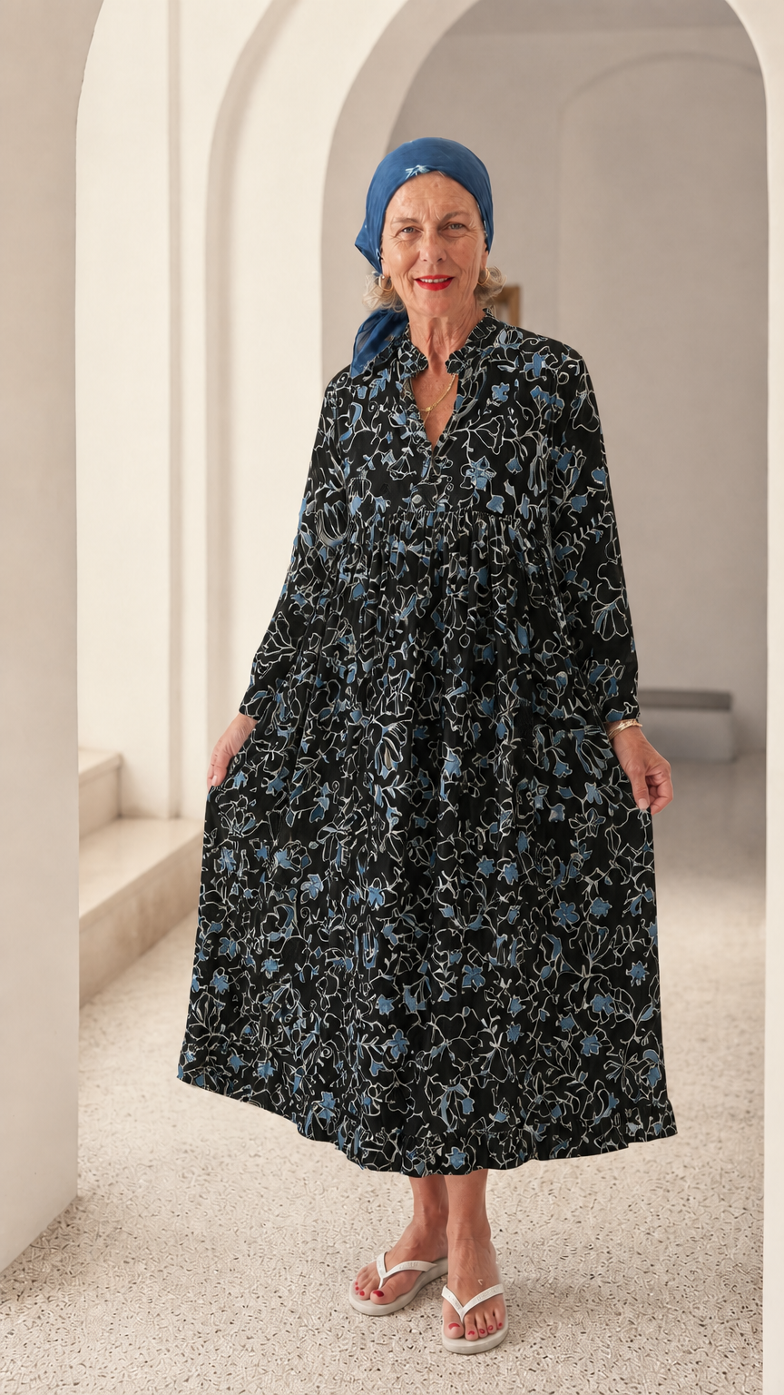 Front view of woman wearing Black floral long sleeve midi smock dress