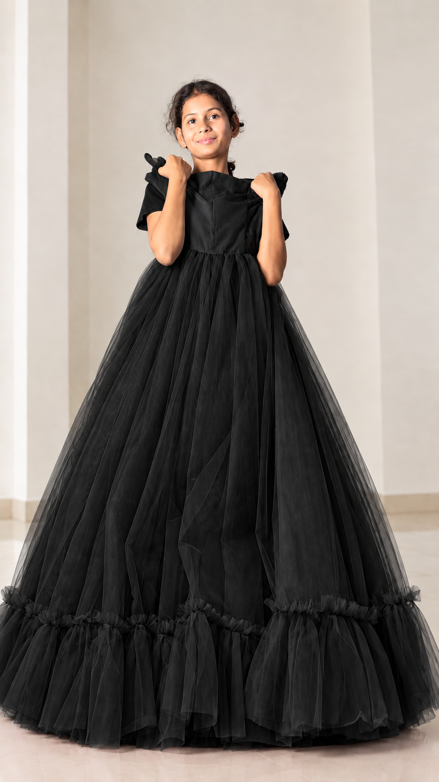 Front view of model wearing black layered tulle maxi ball gown