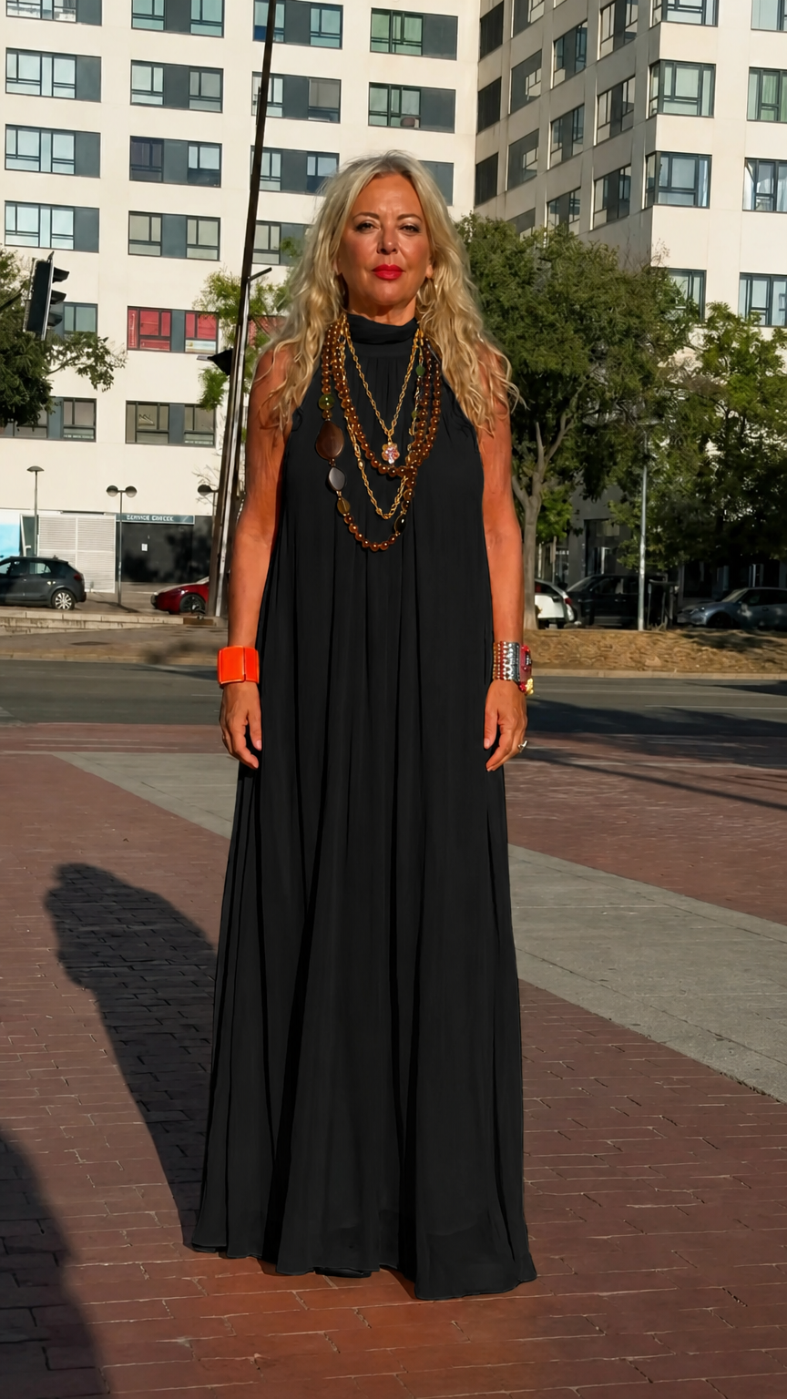 Front full-length view of woman wearing black high neck sleeveless chiffon maxi dress