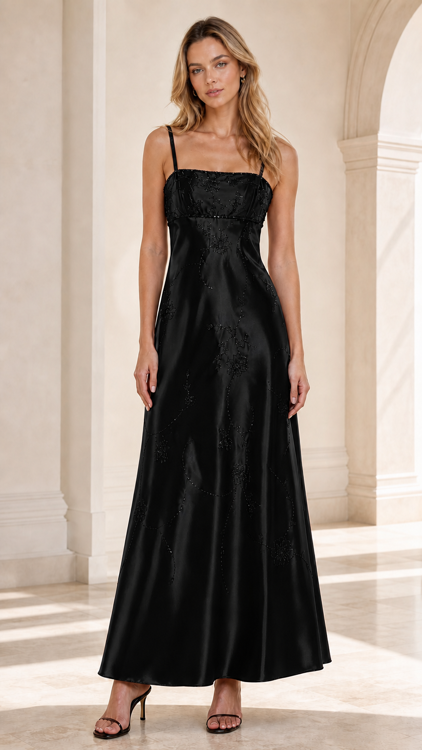 Front view of woman wearing Black embroidered satin spaghetti strap maxi dress