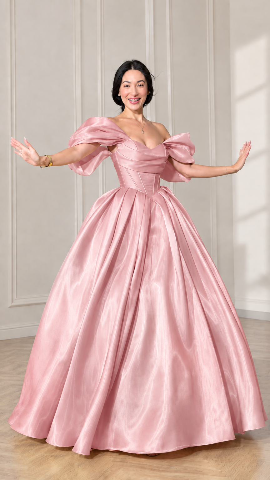Front view of model wearing a soft pink off-shoulder puff sleeve corset ball gown