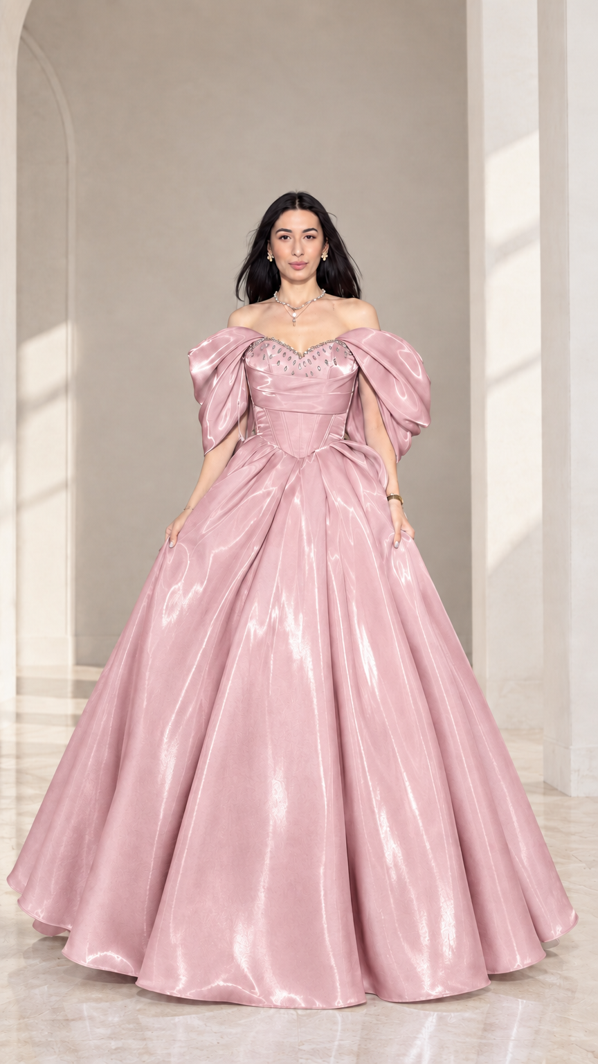 Front view of model wearing blush pink off-shoulder beaded corset ball gown