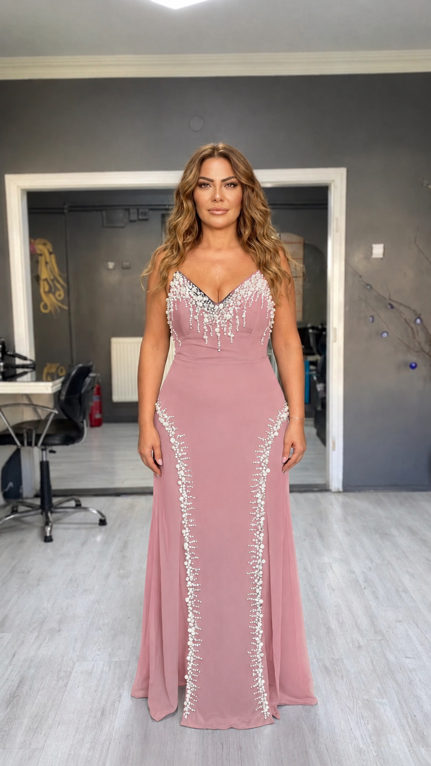 Woman wearing dusty pink pearl-embellished spaghetti strap evening maxi gown