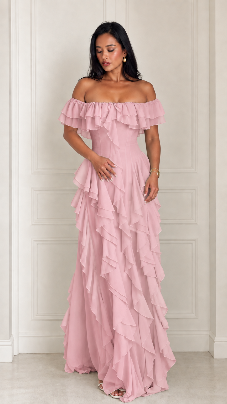 Model posing in the blush pink off-the-shoulder cascading ruffle evening maxi dress