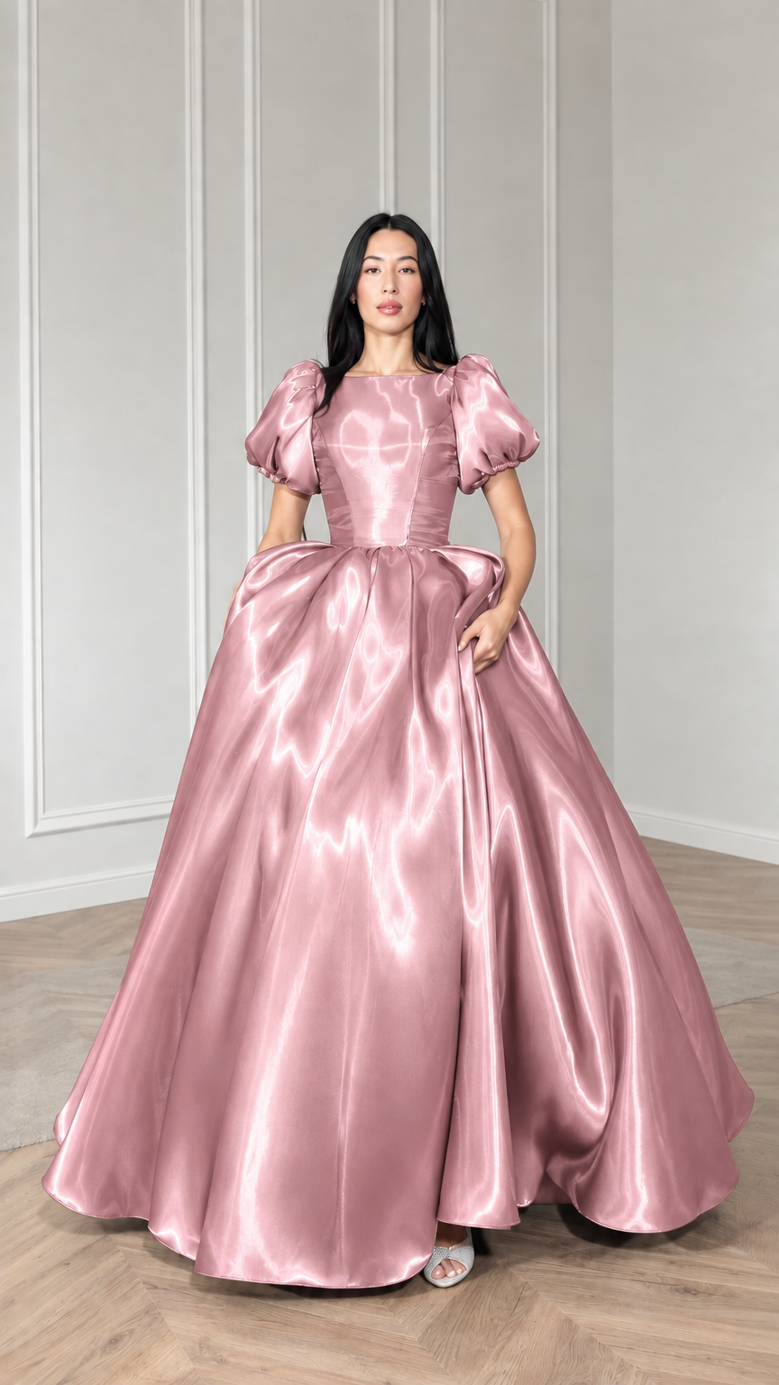 Front view of model wearing blush pink satin puff sleeve ball gown
