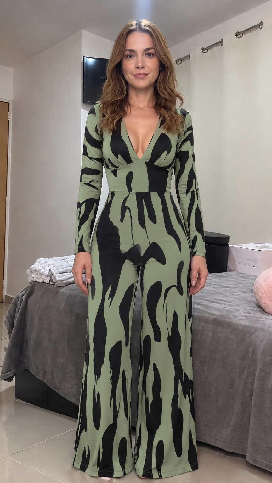 Front view of model wearing olive green and black abstract print wide leg jumpsuit