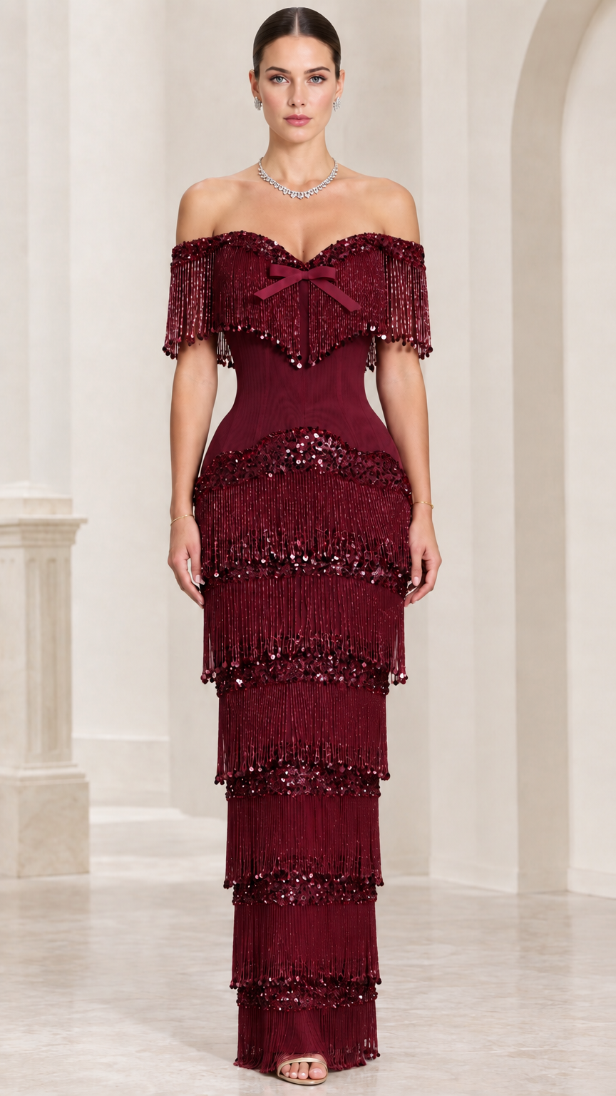 Model wearing burgundy off-shoulder tiered fringe sequin formal gown