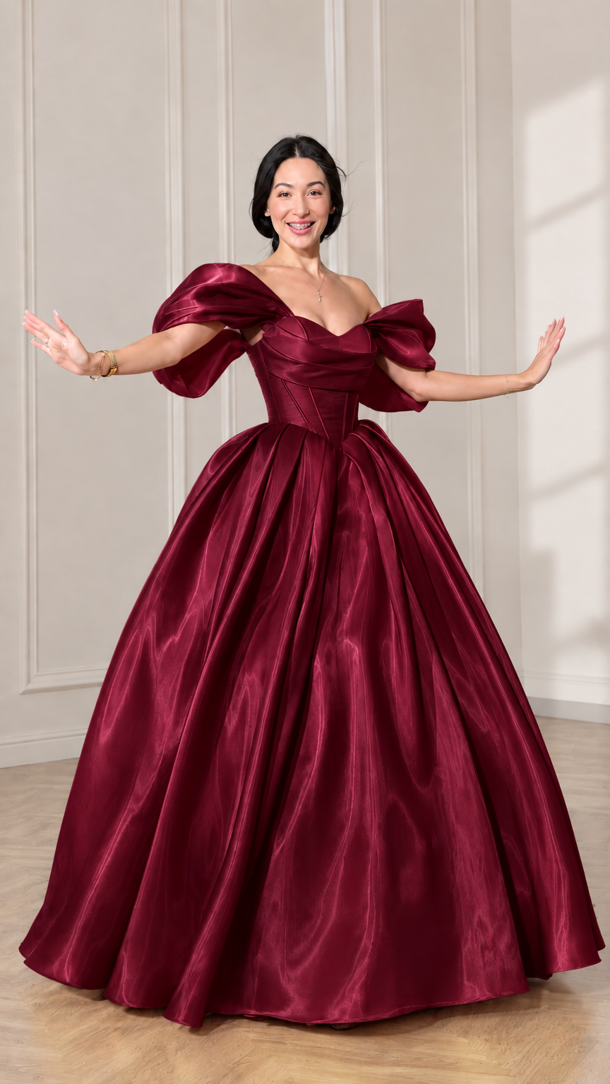 Front view of model wearing a deep burgundy off-shoulder puff sleeve corset ball gown