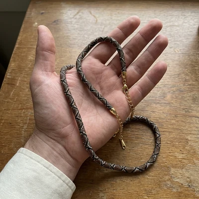 Bronze necklace held in hand