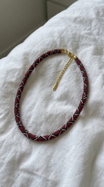 Crimson necklace on white fabric