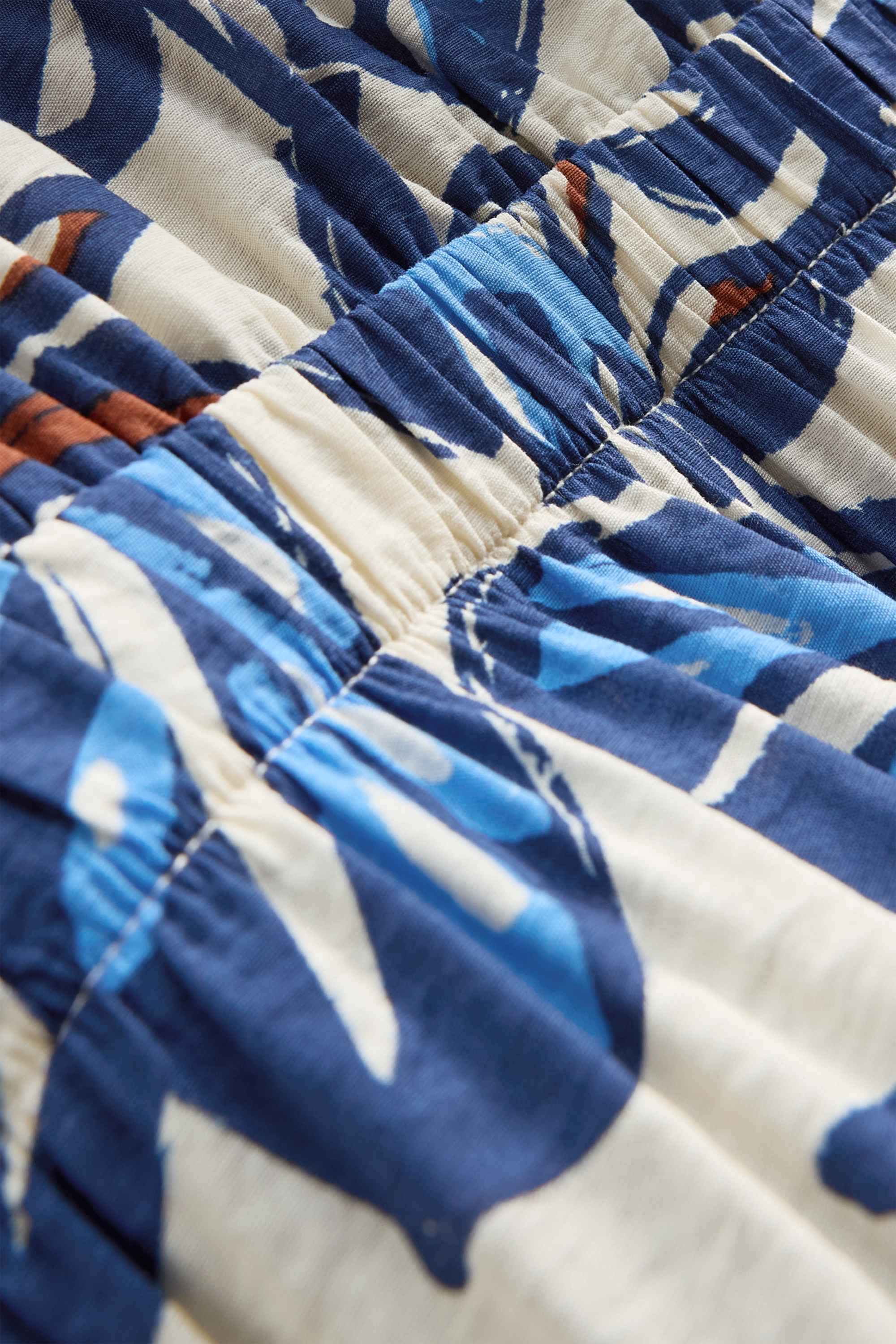 V-neck jumpsuit with beads - patterned blue / white