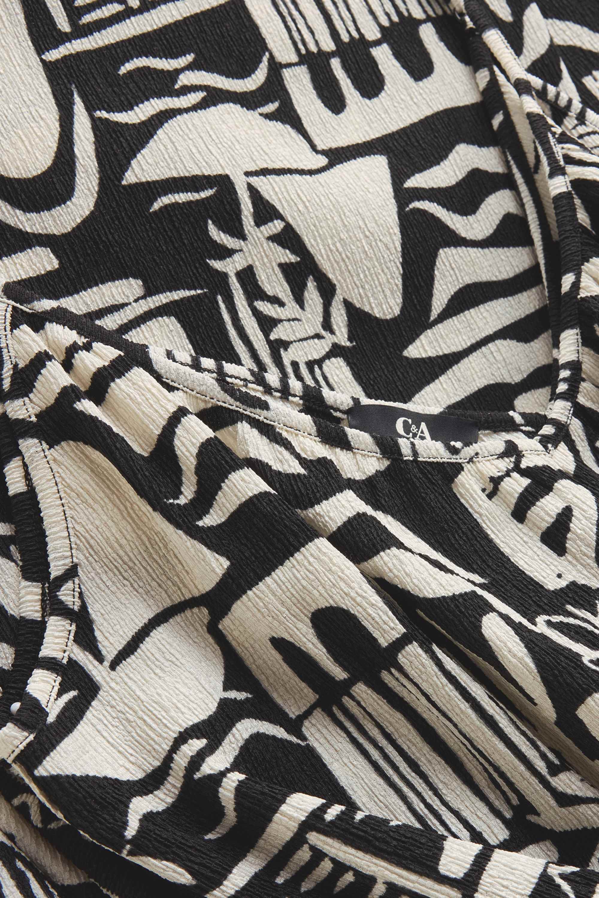 V-neck jumpsuit and belt - patterned black / white
