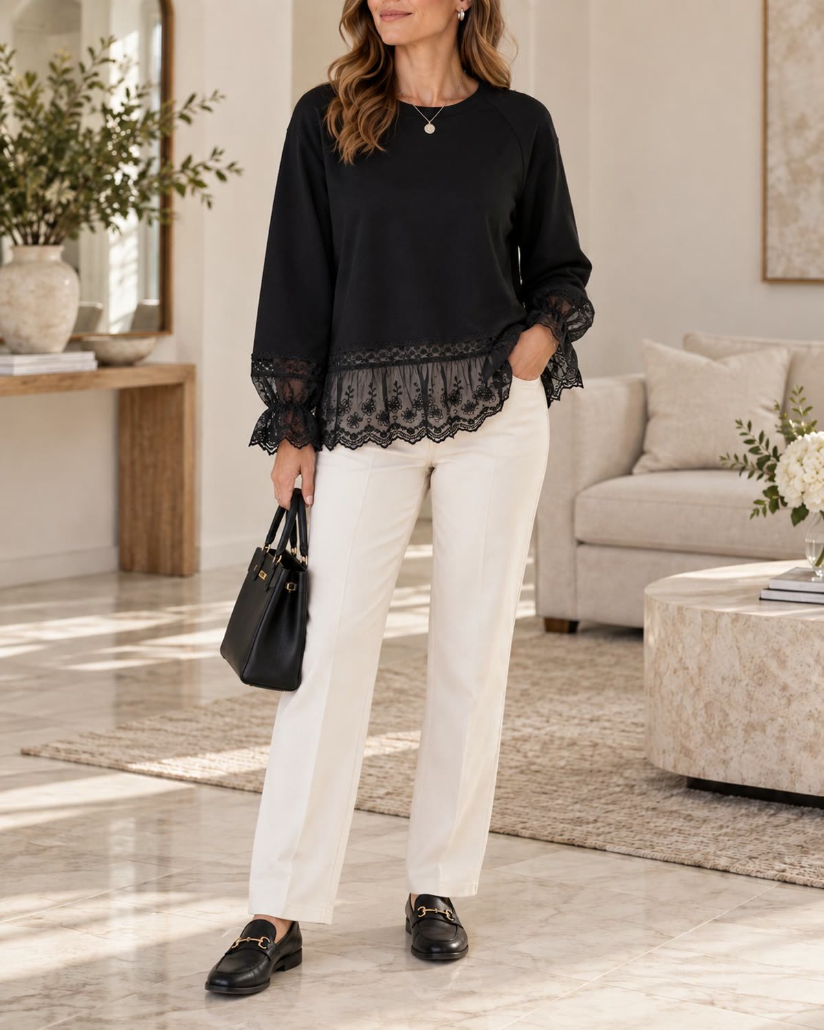Black lace-trim sweatshirt styled with ivory trousers and loafers
