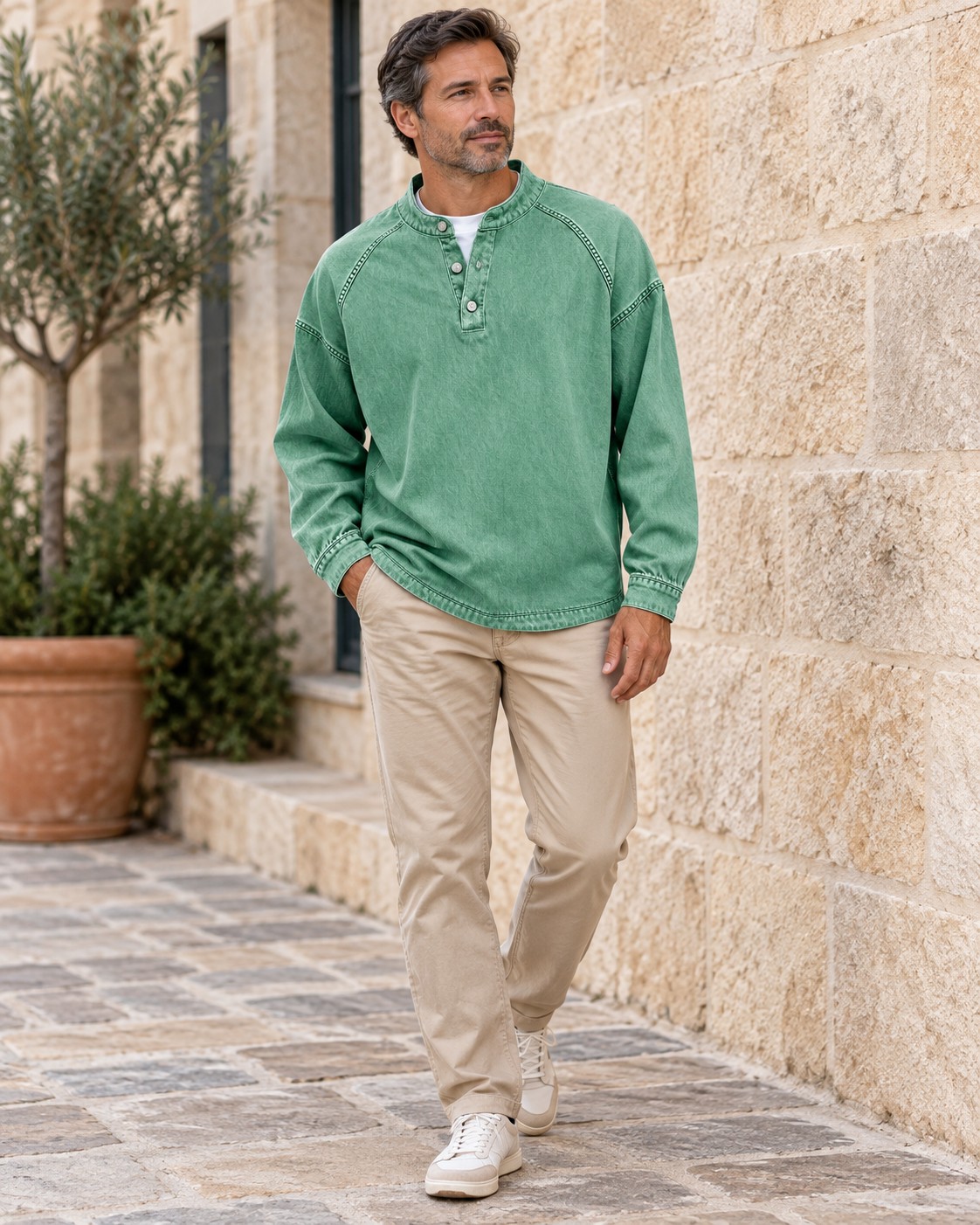 Green Henley paired with neutral chinos