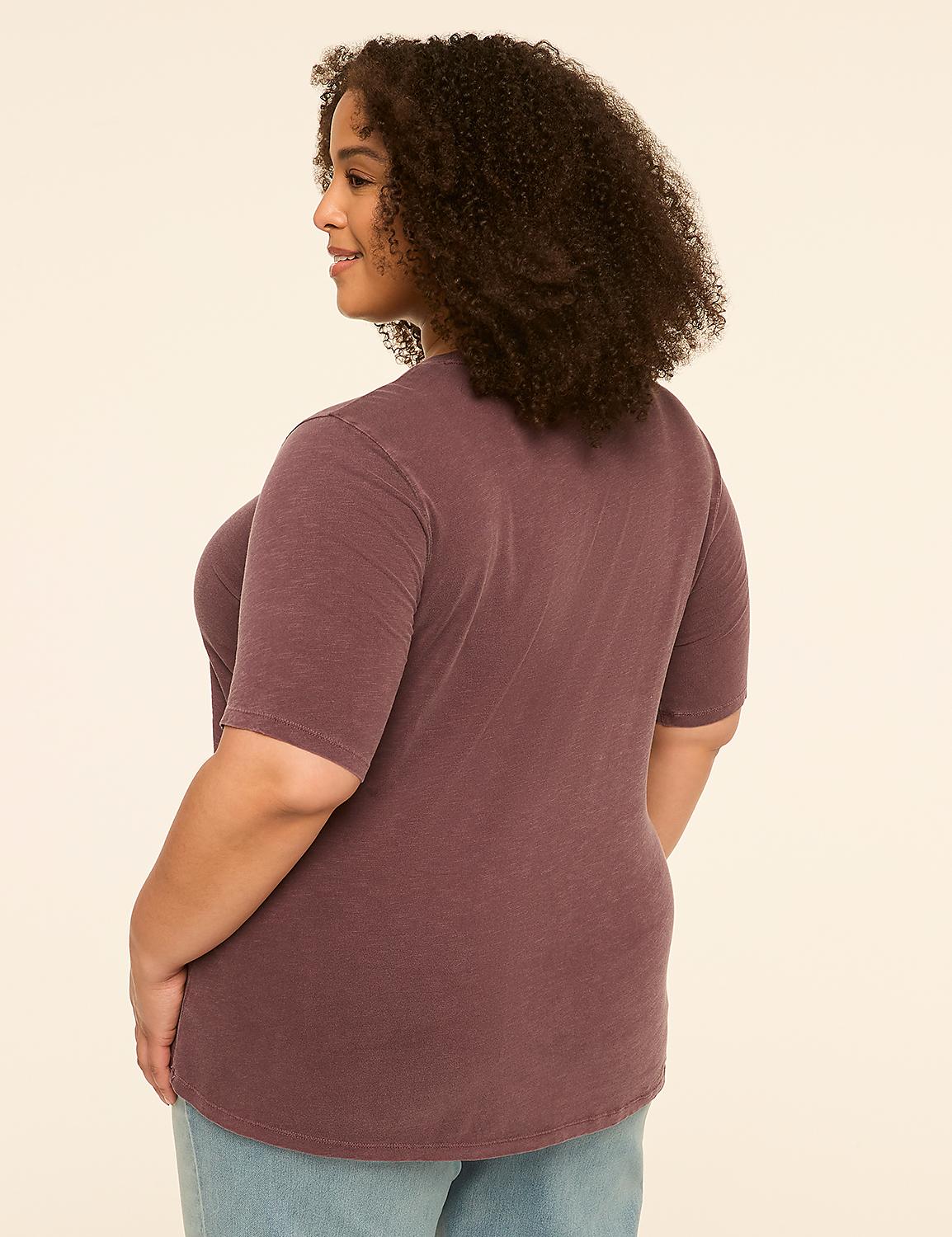 A woman with curly brown hair, wearing a purple t-shirt and blue jeans, stands against a plain cream background. Product Image 2