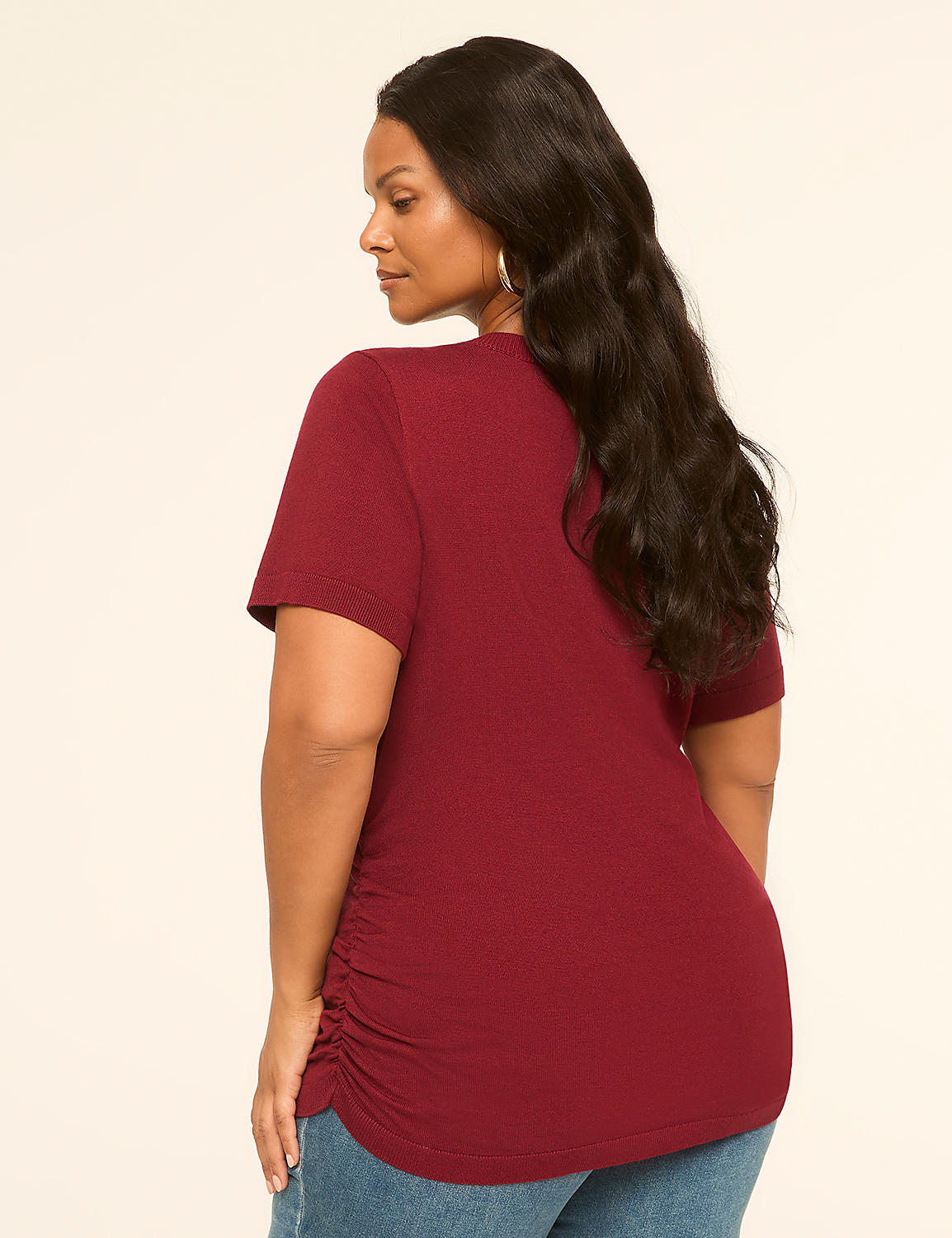 A woman in a maroon t-shirt and jeans stands against a plain, light-colored background. Product Image 2