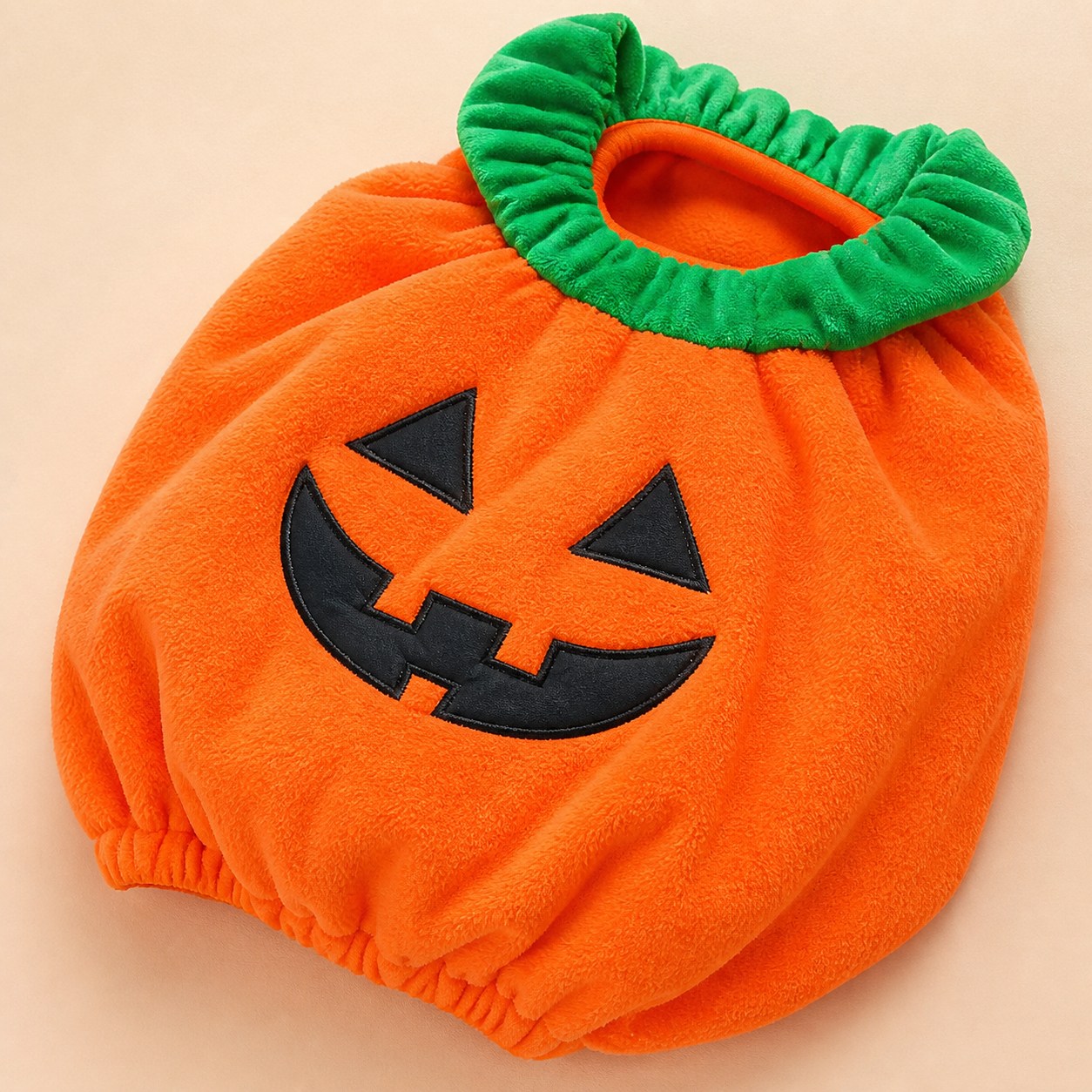 Front detail of the orange padded pumpkin costume and jack-o-lantern applique