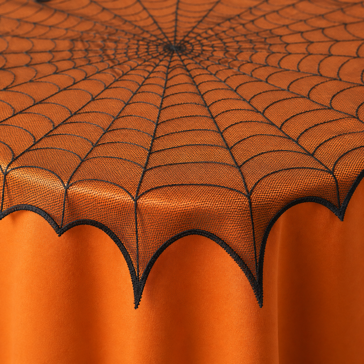 Close detail of the scalloped web-point edge and sheer textile