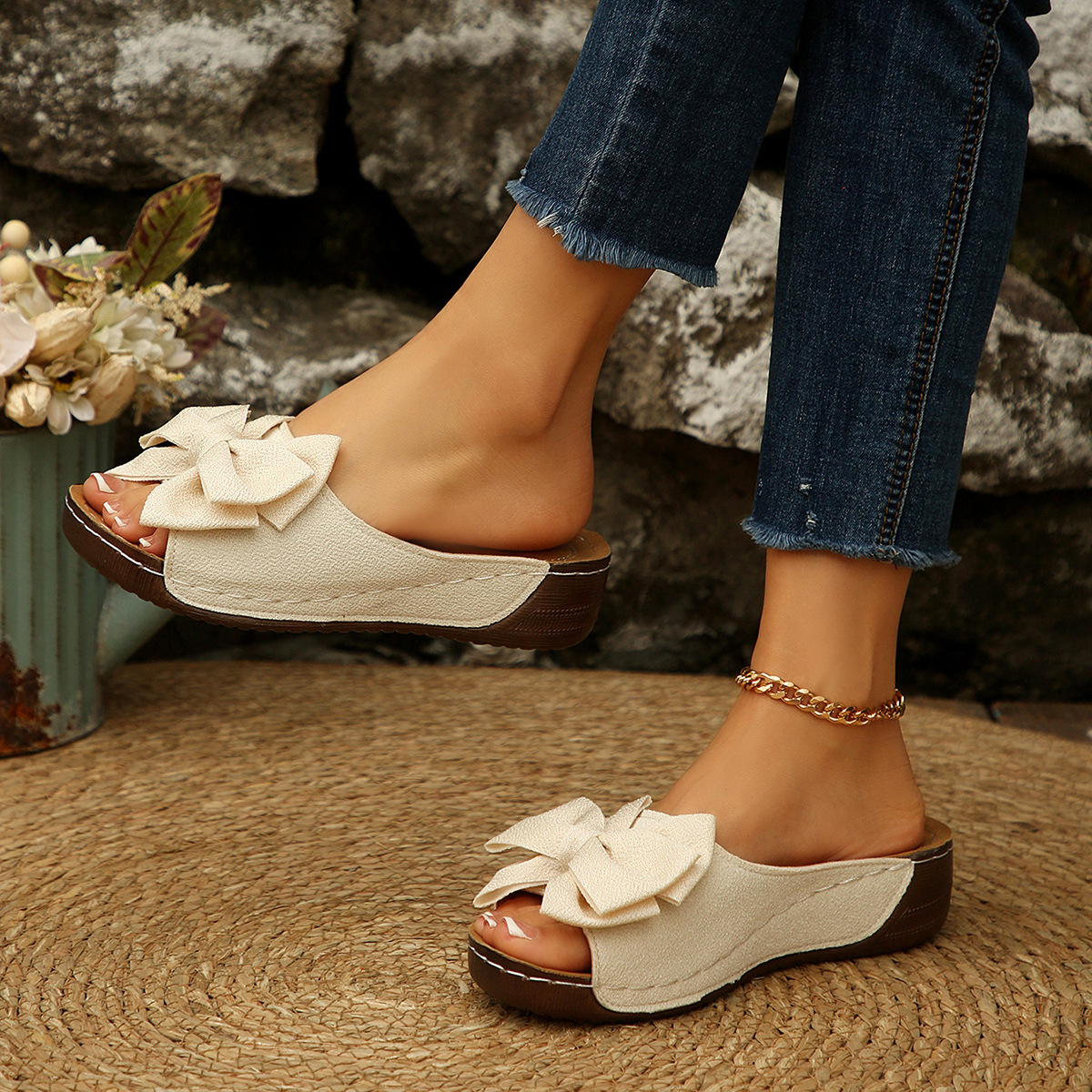 Bow-detail open-toe wedge slide sandals shown on feet