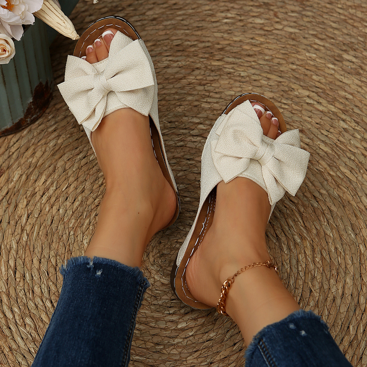 Bow-detail open-toe wedge slide sandals shown on feet
