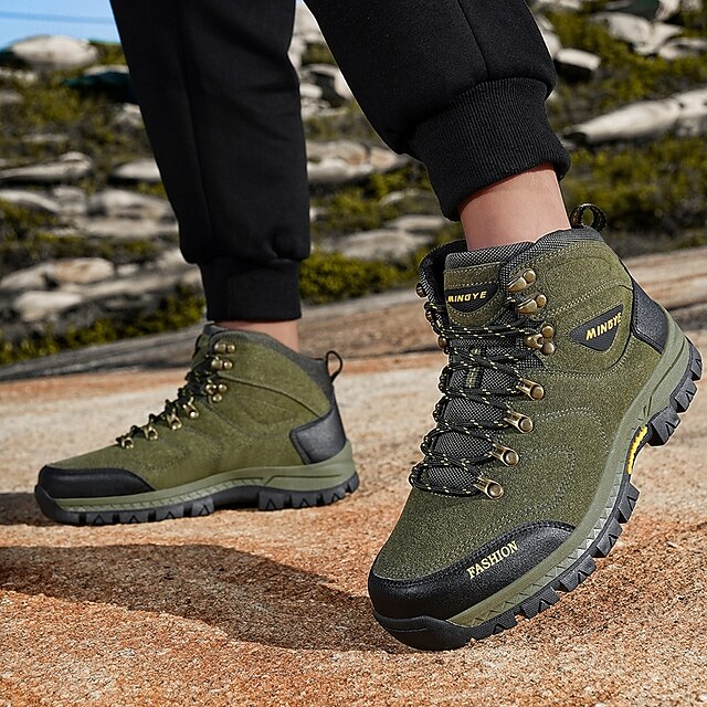Green hiking boots styled with dark cuffed trousers