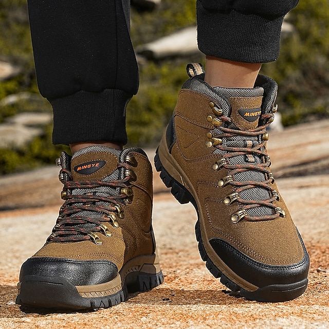 Front view of brown hiking boots worn with black pants