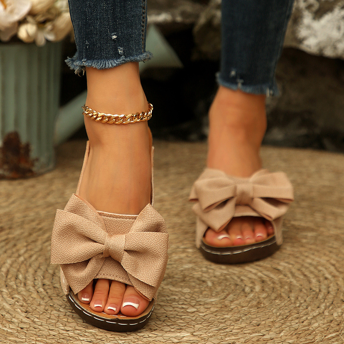 Bow-detail open-toe wedge slide sandals shown on feet
