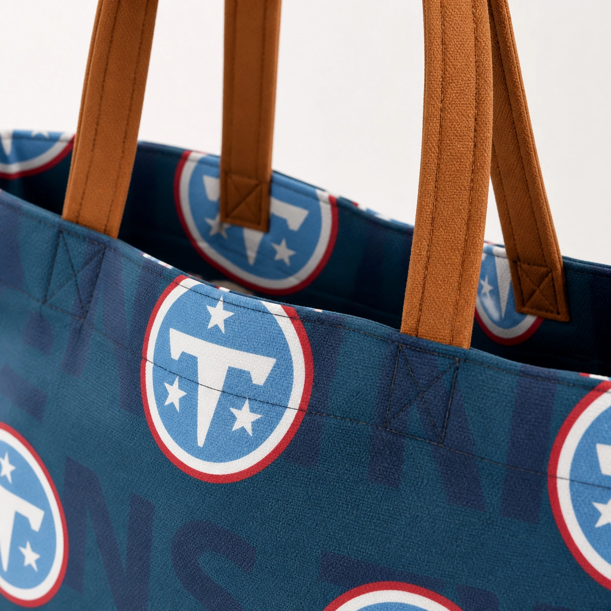 Close view of brown tote handles and reinforced top seam
