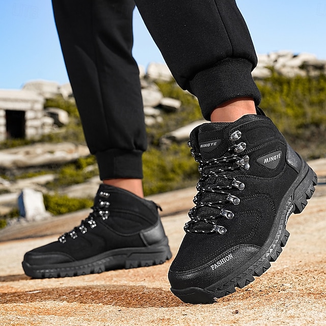 Black boots worn with dark pants from a three-quarter angle