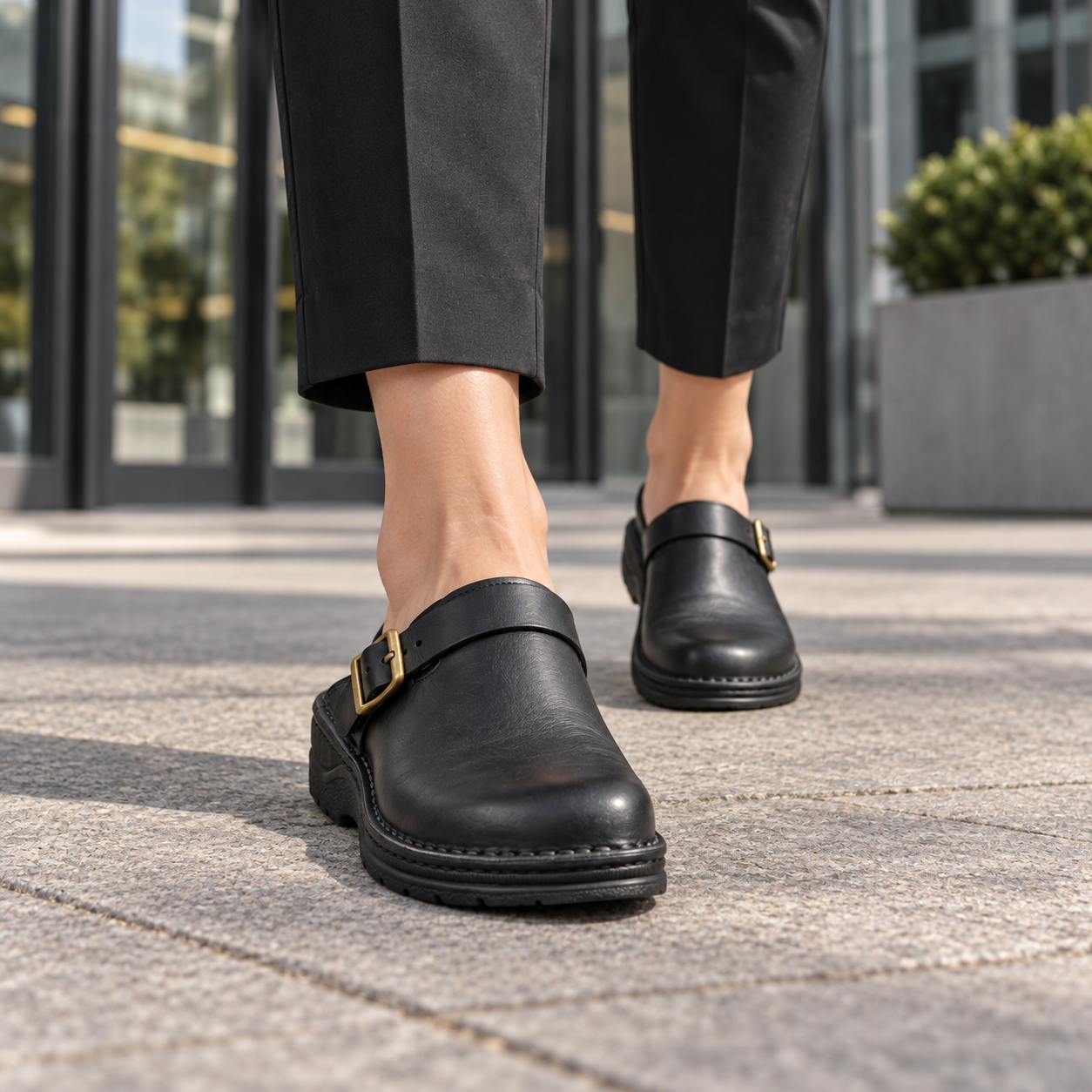 Adult model wearing Olivia black open-back buckle clogs