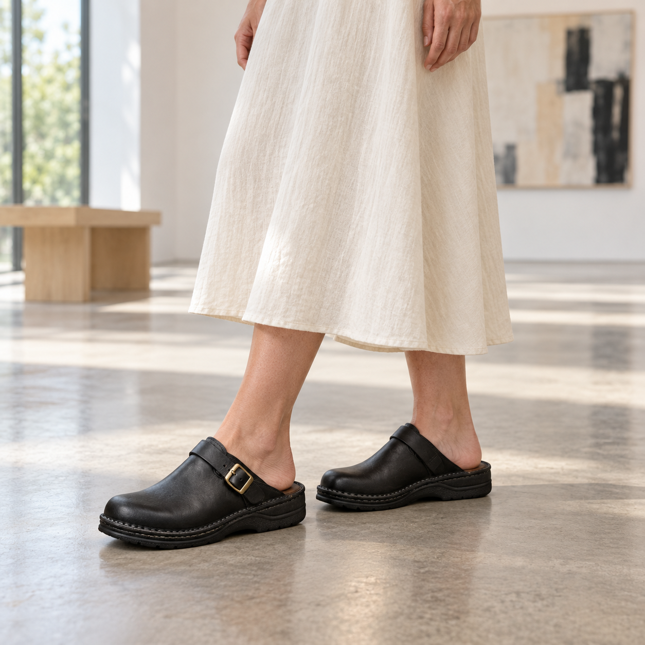 Adult model wearing Olivia black open-back buckle clogs